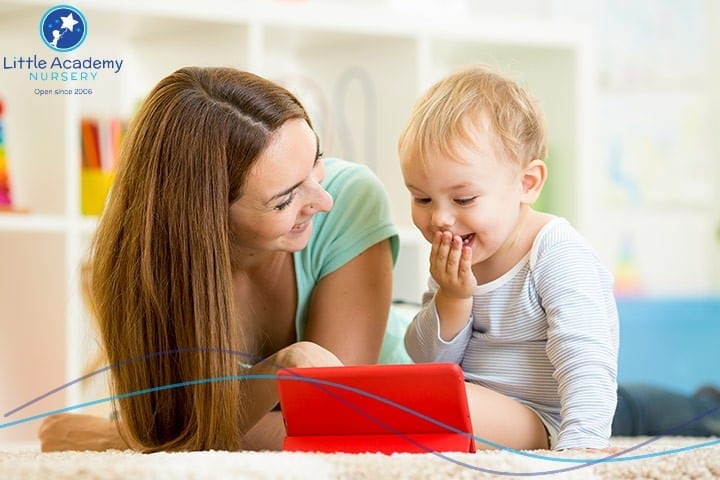 A Woman on the left side of the picture and beside her a little kid is laughing.